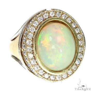 14K gold ring with oval opal center surrounded by double diamond halo.
