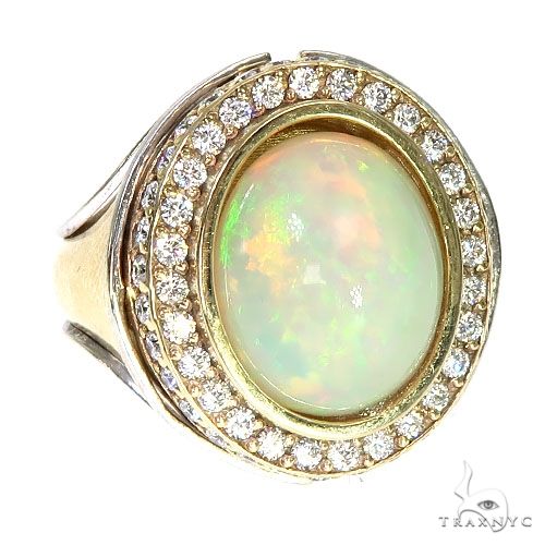 14K gold ring with oval opal center surrounded by double diamond halo
