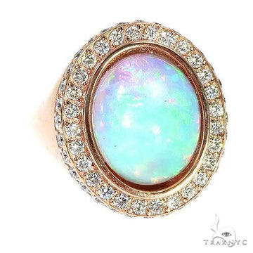 14K rose gold ring with oval opal center stone surrounded by diamonds.
