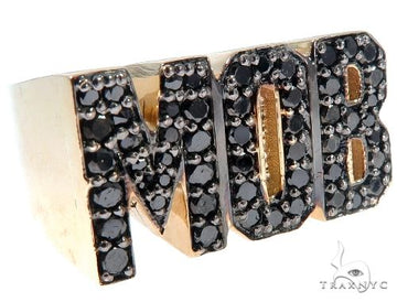 Gold ring with black diamonds spelling MOB in bold block letters.