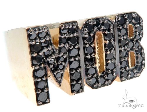 Gold ring with black diamonds spelling MOB in bold block letters