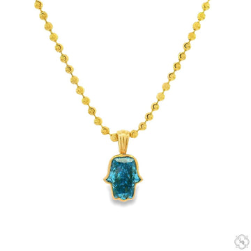 Yellow gold chain necklace with custom cut blue diamond Hamsa pendant.