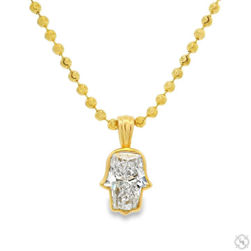 Yellow gold chain with diamond-encrusted Hamsa hand pendant.