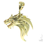 Yellow gold pendant shaped like a fierce firewolf head with sharp detailing and polished finish.