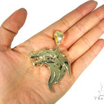 Yellow gold pendant shaped like a fierce firewolf head with sharp detailing and polished finish.