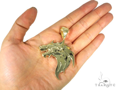 Yellow gold pendant shaped like a fierce firewolf head with sharp detailing and polished finish.