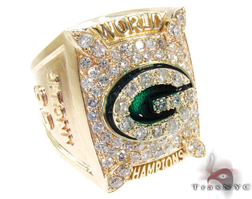 Yellow gold Super Bowl ring with green team logo and sparkling clear stones.