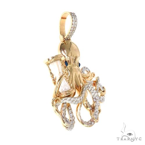 14K yellow gold octopus pendant with blue gemstone eyes and diamond accents on tentacles