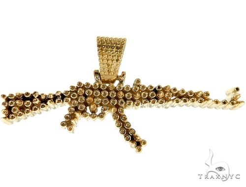 Gold AK-47 pendant with intricate beaded detailing and textured bail loop