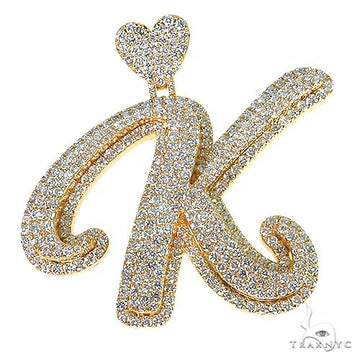 Yellow gold diamond-encrusted custom initial K pendant with heart detail.