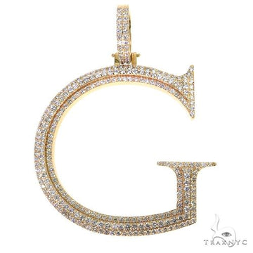Yellow gold diamond-encrusted initial G pendant with pave-set stones and polished edges.