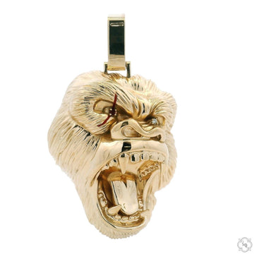 Yellow gold gorilla head pendant with open mouth and detailed fur texture.