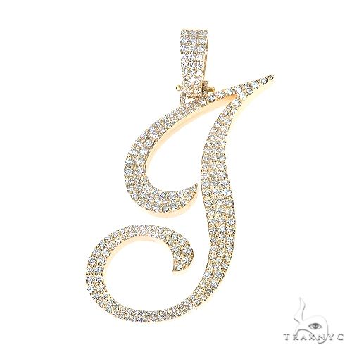 Yellow gold diamond-encrusted initial J pendant with intricate swirls and sparkling stones