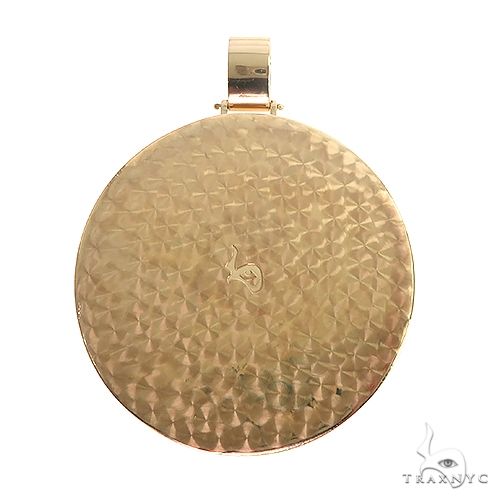 Yellow gold round medallion pendant with textured surface and engraved initial C