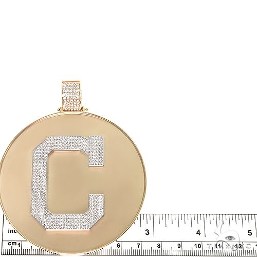 Round yellow gold medallion pendant with diamond-studded letter "C" and bail detail