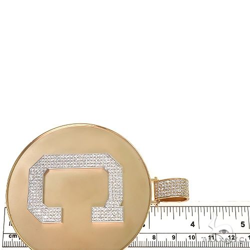 Yellow gold medallion pendant with diamond-studded letter C and textured bail