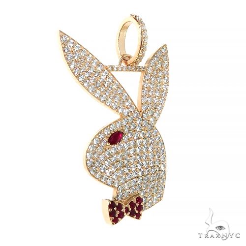 Yellow gold Playboy rabbit pendant encrusted with diamonds and red gemstone eye and bow tie