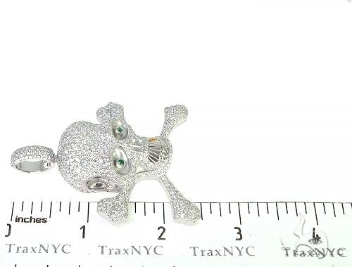 White gold diamond skull pendant with green eyes and detailed bone design