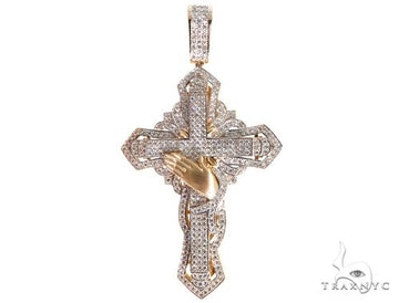 Diamond-studded diamond cross pendant with gold praying hands in white and yellow gold.
