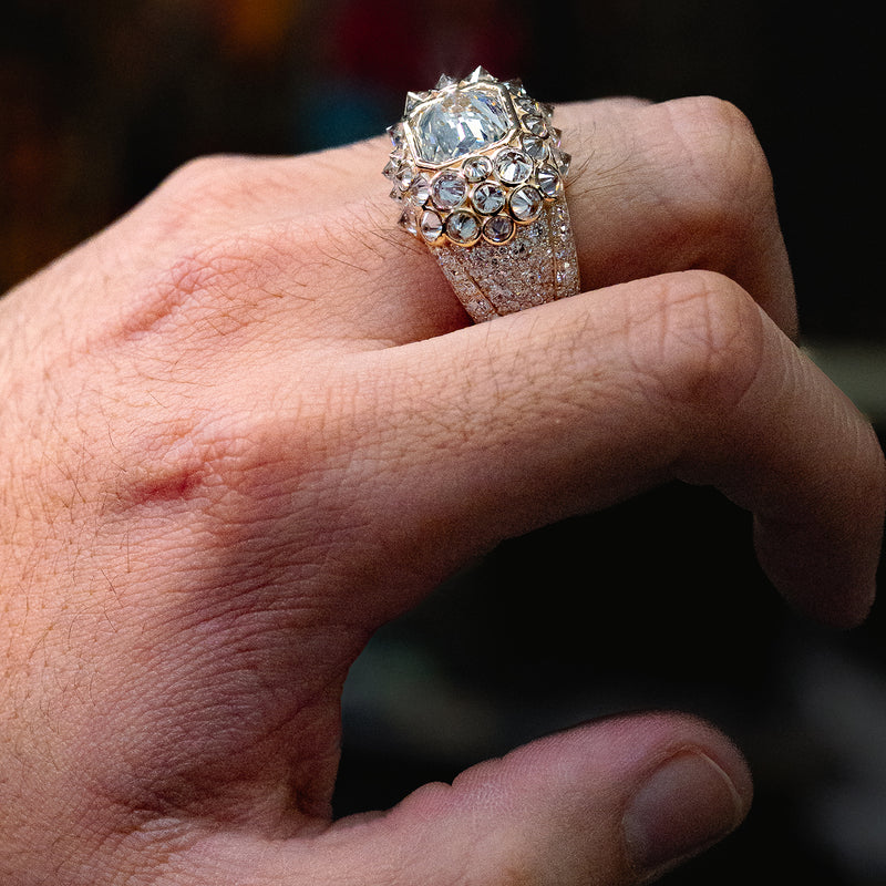 Yellow gold men’s ring with large diamond cluster and pavé diamond detailing.