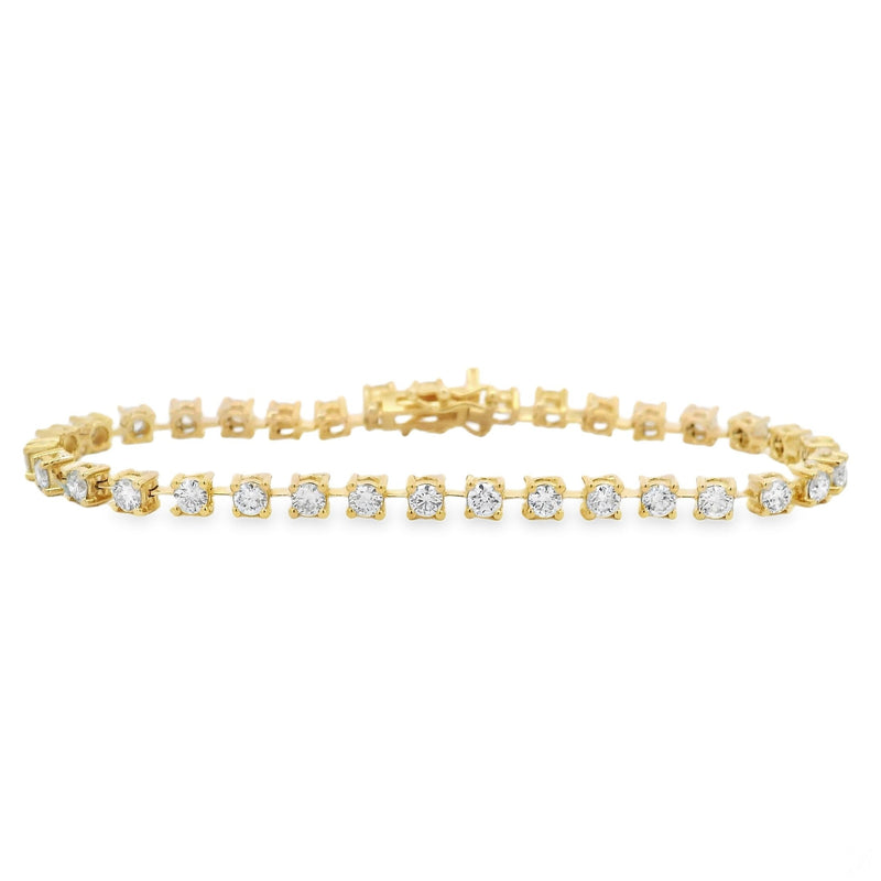 Yellow gold tennis bracelet with small round diamonds in prong settings