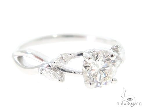 White gold daisy design engagement ring with round diamond center stone and leaf accents