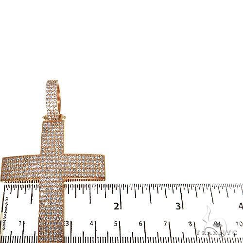 Rose gold diamond cross pendant with pavé-set diamonds and a large diamond bail, measured against ruler