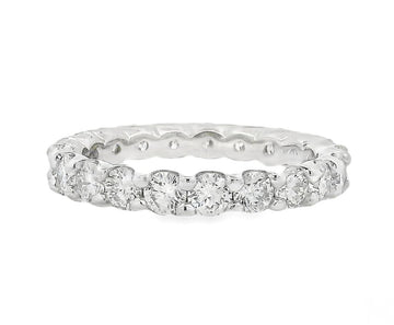 White gold diamond eternity band with round-cut stones in shared prong setting.