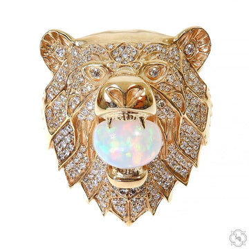 Yellow gold grizzly bear ring with diamonds and a large opal gemstone in the mouth.