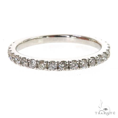 White gold diamond wedding band with round-cut stones set in a shared prong style