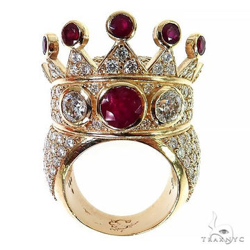 Yellow gold crown ring with ruby and diamond gemstones in intricate design.