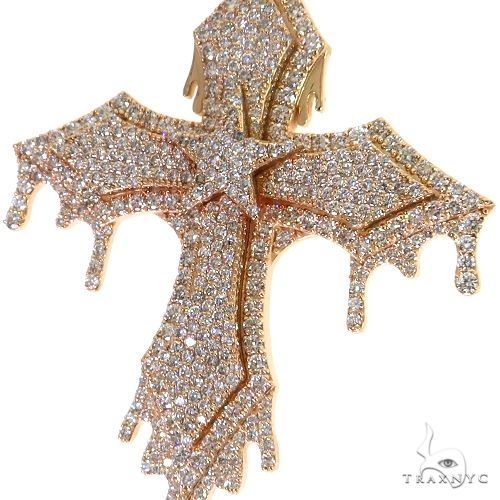 Yellow gold cross pendant with drip design and pave diamond accents