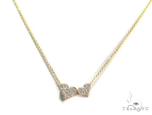 14K yellow gold necklace with two interlinked diamond-set hearts