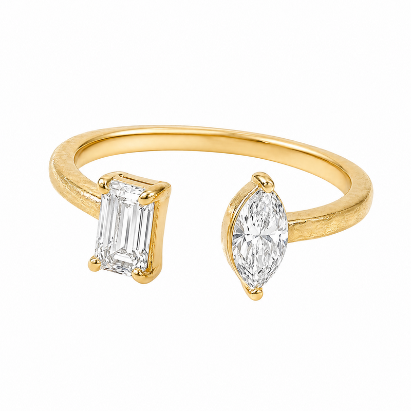 Gold open ring with emerald-cut and marquise-cut diamonds on each end.