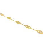 Gold bracelet with evil eye motifs adorned with yellow diamonds and clear stones.