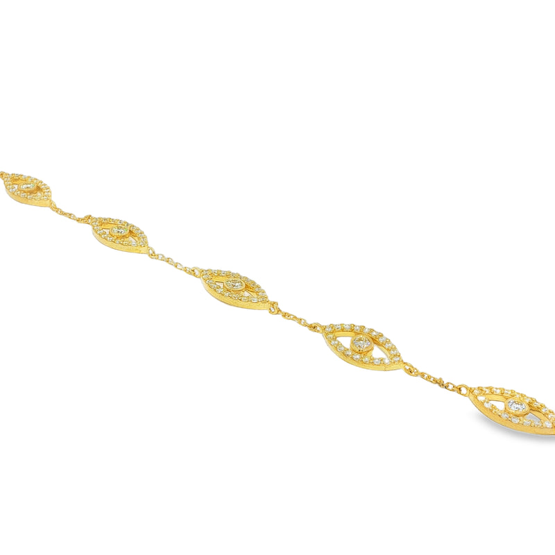 Gold bracelet with evil eye motifs adorned with yellow diamonds and clear stones.
