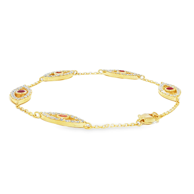 Gold bracelet with five evil eye charms featuring white diamonds and central rubies.