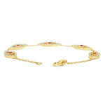 Gold bracelet with five evil eye charms featuring white diamonds and central rubies.