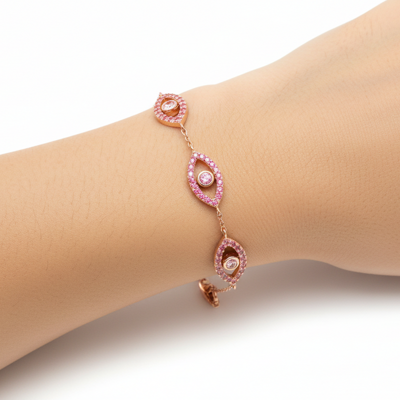 Rose gold evil eye bracelet with pink diamonds and delicate chain links.