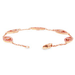 Rose gold evil eye bracelet with pink diamonds and delicate chain links.