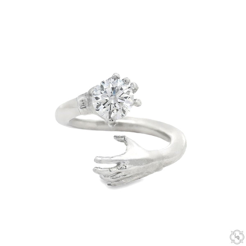 Sculpted hand diamond ring in polished .925 silver cradling a round brilliant diamond, front angle