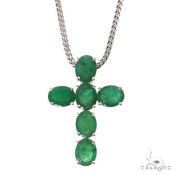Sterling silver cross pendant with oval emerald gemstones on silver chain.