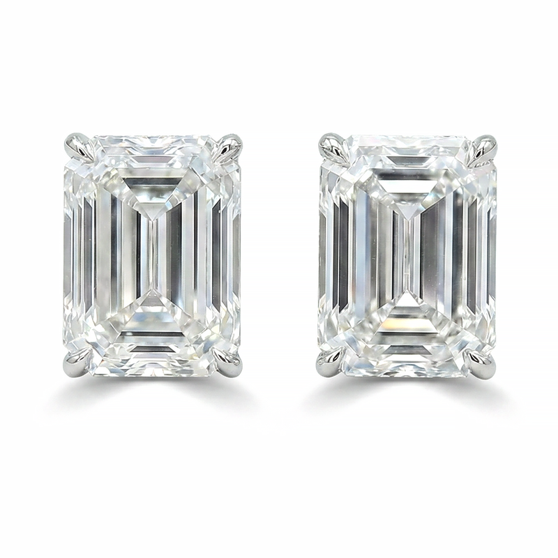 Pair of emerald cut diamond stud earrings with four-prong white gold setting