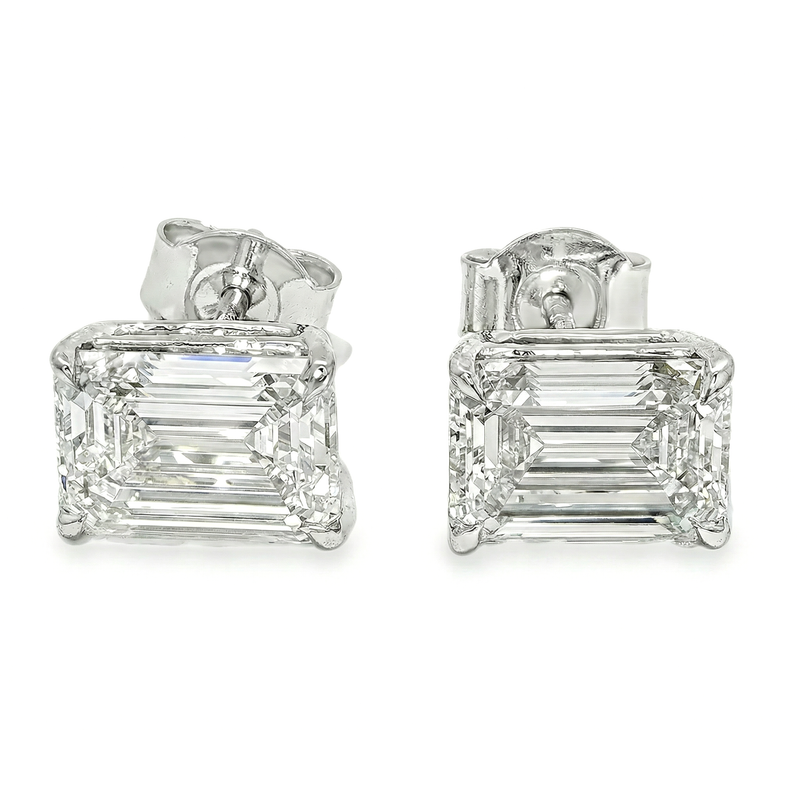 Pair of emerald cut diamond stud earrings with four-prong white gold setting