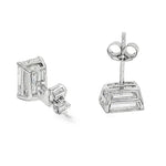 Pair of emerald cut diamond stud earrings with four-prong white gold setting