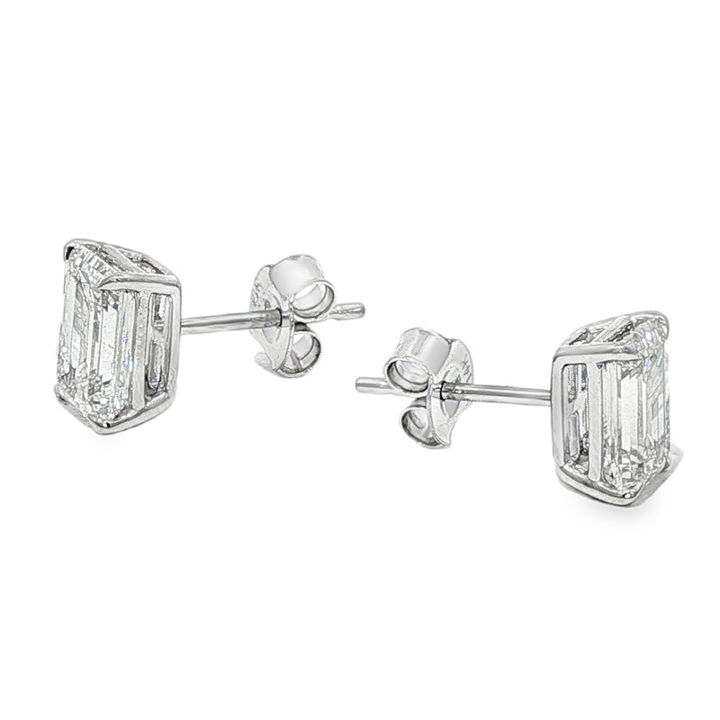 Pair of emerald cut diamond stud earrings with four-prong white gold setting