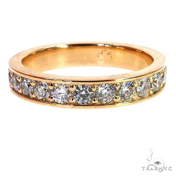 Yellow gold eternity wedding band with round diamonds encircling the band.