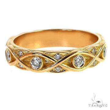 Yellow gold wedding band with infinity design and inset round diamonds.
