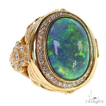 Yellow gold ring with large Ethiopian opal and diamond halo on textured band.