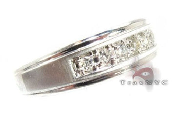 Mens diamond band ring with prong set stones in a full band layout, angled to show stone row